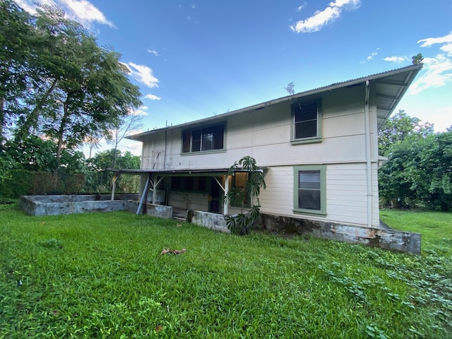 rear view of property with a yard