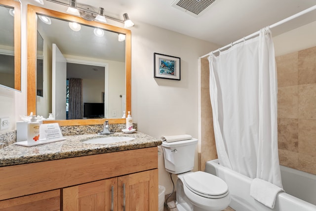 full bathroom featuring shower / bath combo, vanity, and toilet