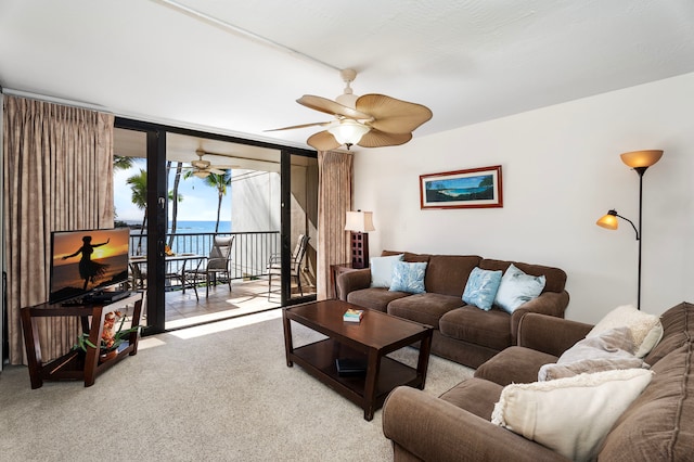 living room with ceiling fan, floor to ceiling windows, and light carpet