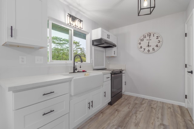 kitchen featuring sink, black electric range oven, white cabinetry, and light hardwood / wood-style floors