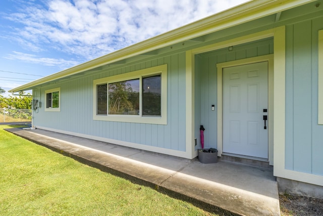 property entrance with a yard