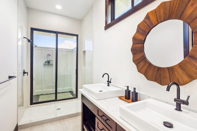 bathroom featuring vanity, tile patterned floors, and tiled shower