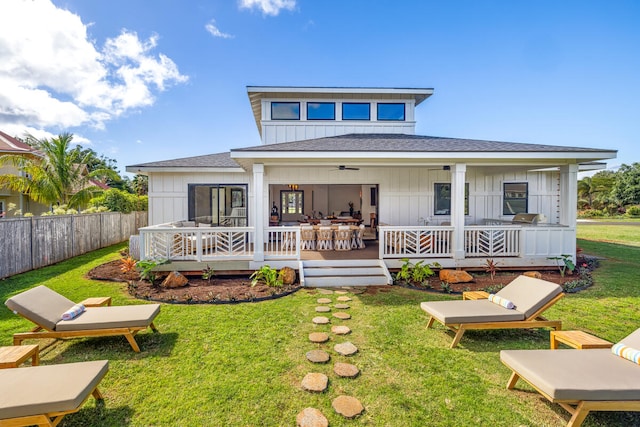 rear view of property with a yard