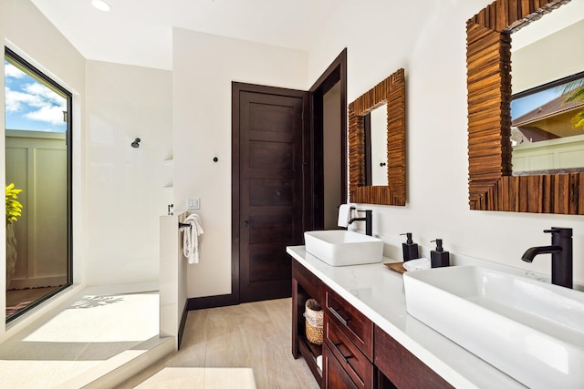 bathroom featuring vanity, a shower, and hardwood / wood-style flooring