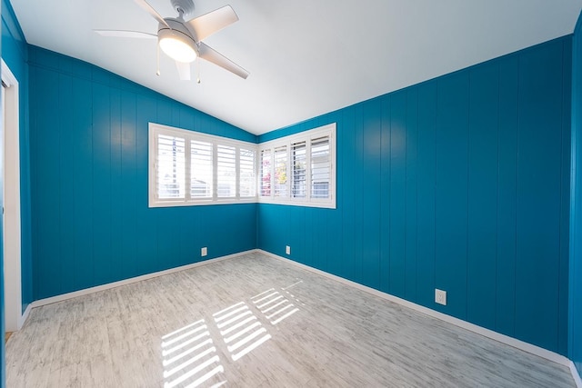 spare room with vaulted ceiling, ceiling fan, and light hardwood / wood-style floors