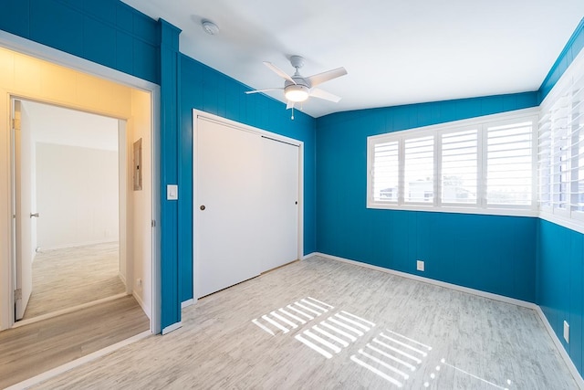 unfurnished bedroom featuring ceiling fan, a closet, lofted ceiling, and light hardwood / wood-style flooring