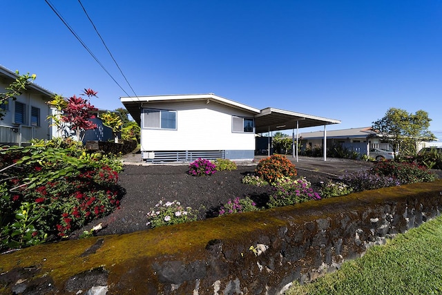 back of property with a carport