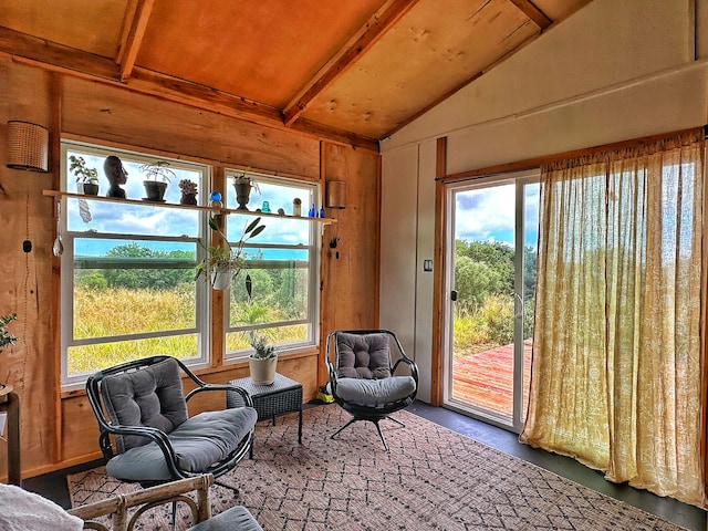 sunroom featuring lofted ceiling with beams