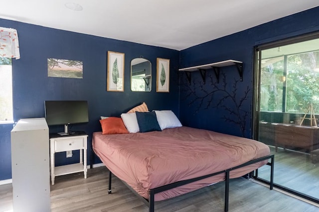 bedroom with hardwood / wood-style flooring