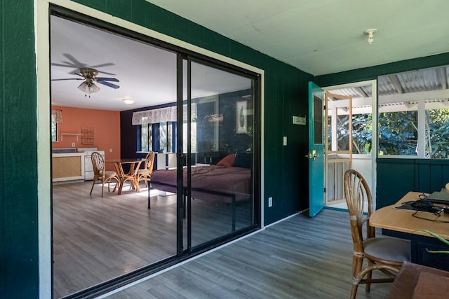 doorway to outside with ceiling fan and hardwood / wood-style floors