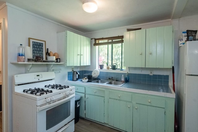 kitchen with dark hardwood / wood-style flooring, white appliances, crown molding, and sink