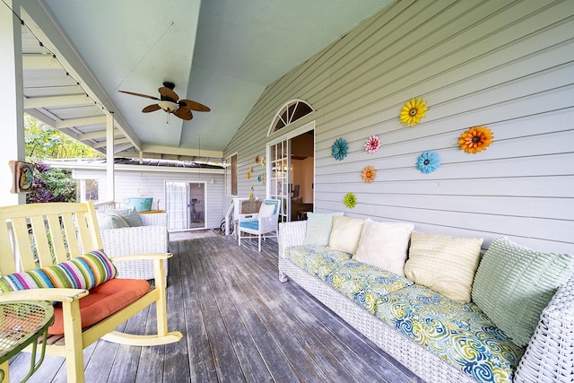 deck featuring ceiling fan and an outdoor living space