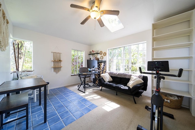 workout room featuring a skylight, ceiling fan, and carpet