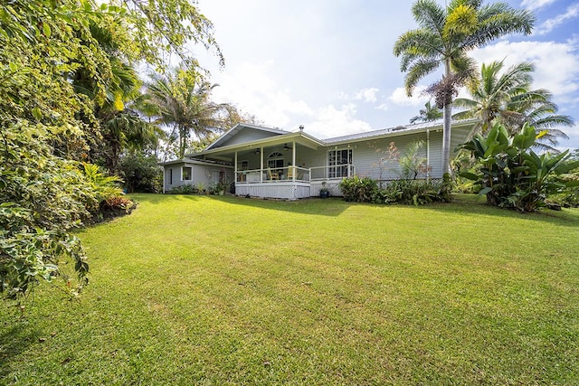 exterior space featuring a lawn and a porch