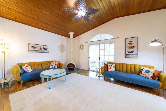 living room with wood ceiling, hardwood / wood-style flooring, ceiling fan, vaulted ceiling, and a wood stove