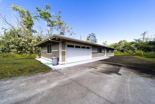 view of front of home featuring a garage and a front lawn