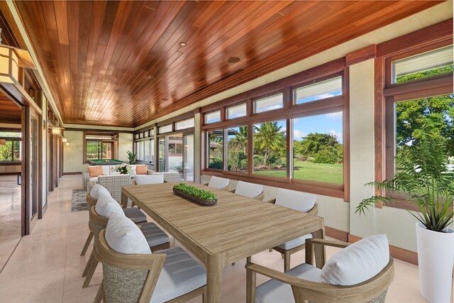 sunroom / solarium with plenty of natural light and wooden ceiling