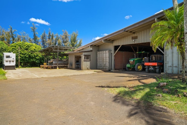 view of side of home featuring an outdoor structure