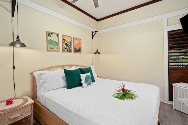 bedroom with dark hardwood / wood-style flooring, ceiling fan, and ornamental molding