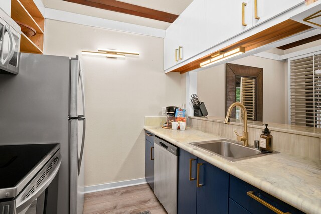 kitchen with blue cabinetry, dishwasher, sink, light hardwood / wood-style flooring, and range