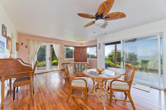 dining space with ceiling fan and light hardwood / wood-style flooring