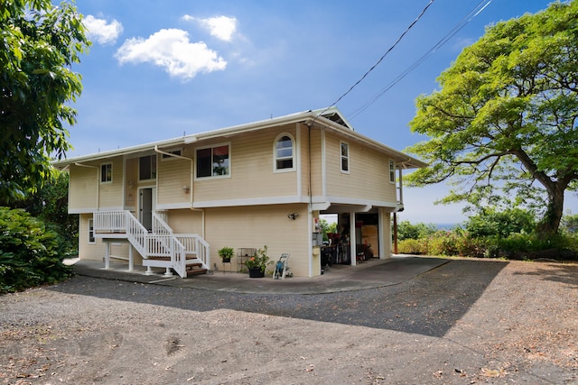 split foyer home featuring a carport