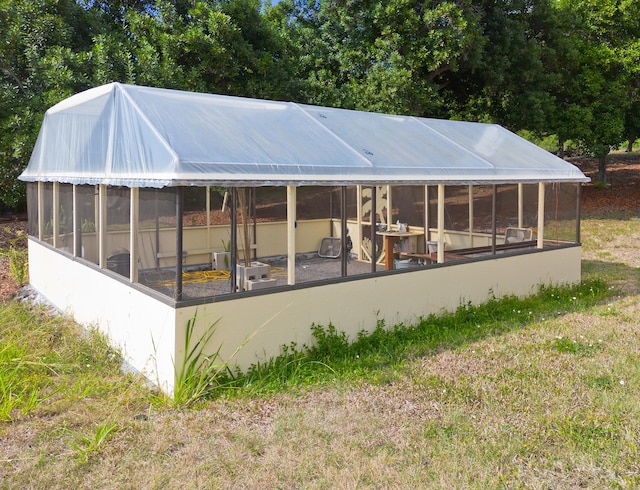 rear view of house featuring a lawn