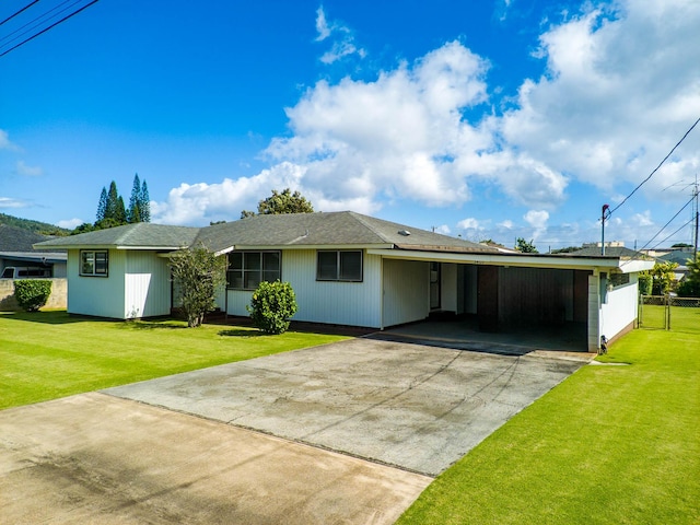 single story home featuring a carport and a front lawn