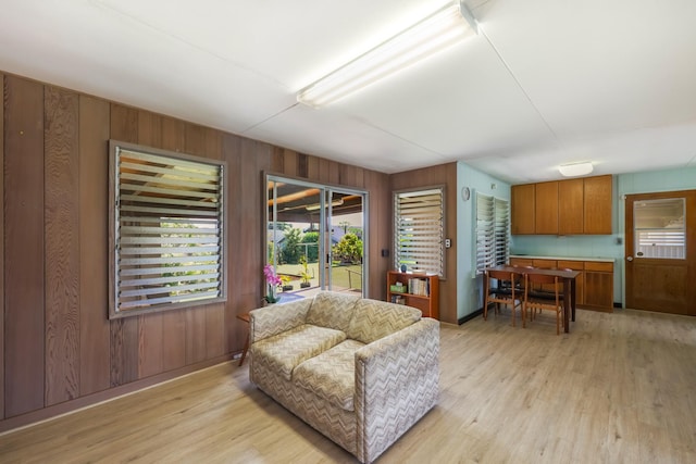 interior space with light hardwood / wood-style floors and wooden walls