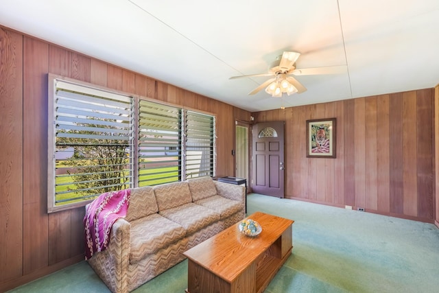 carpeted living room featuring ceiling fan