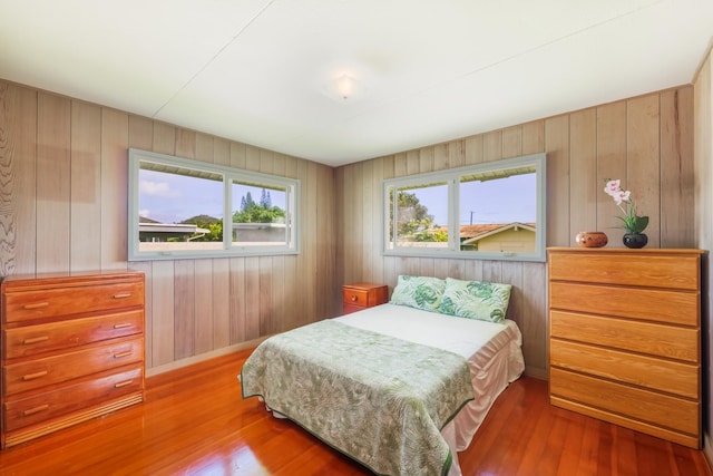 bedroom with hardwood / wood-style floors and multiple windows