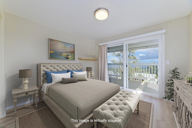 bedroom with access to exterior and light wood-type flooring