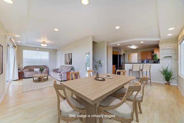 dining room with light hardwood / wood-style flooring and plenty of natural light