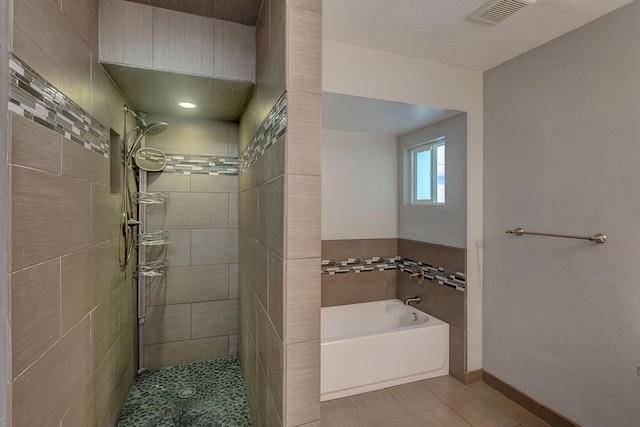 bathroom featuring tile patterned flooring and plus walk in shower