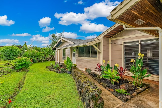 view of property exterior with a lawn