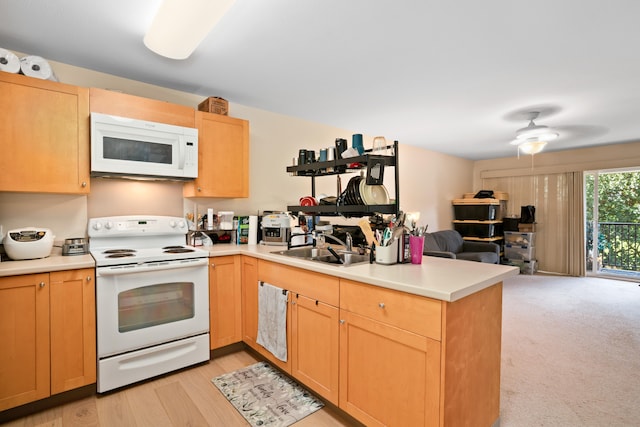 kitchen with sink, white appliances, ceiling fan, light carpet, and kitchen peninsula