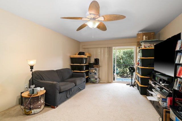 carpeted home office featuring ceiling fan