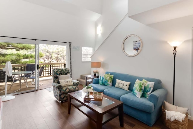 living room featuring hardwood / wood-style flooring and a high ceiling