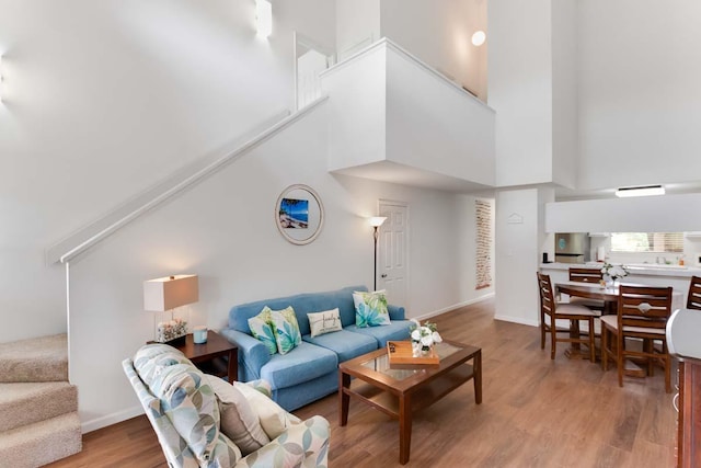 living room with hardwood / wood-style flooring and a high ceiling