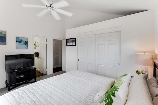 bedroom with radiator heating unit, a closet, vaulted ceiling, and ceiling fan