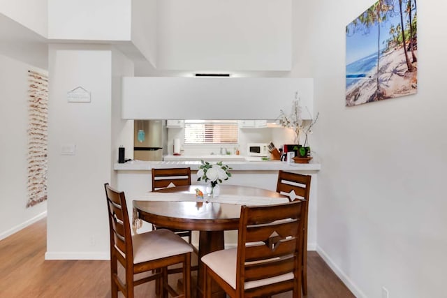 dining area with wood-type flooring