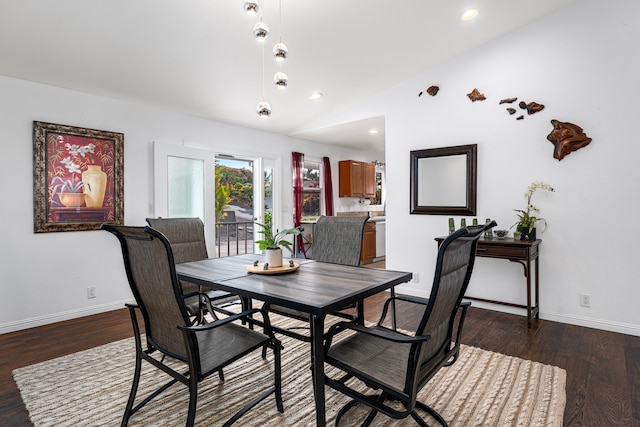 dining room with dark hardwood / wood-style floors and vaulted ceiling