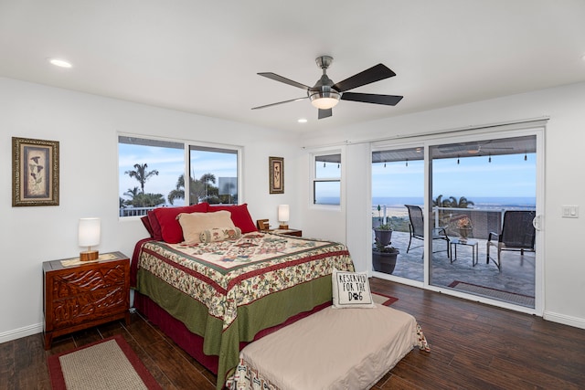 bedroom featuring access to outside, ceiling fan, hardwood / wood-style floors, and a water view