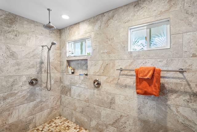 bathroom with plenty of natural light and tiled shower