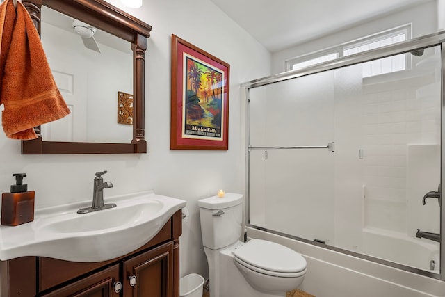 full bathroom with vanity, toilet, and bath / shower combo with glass door