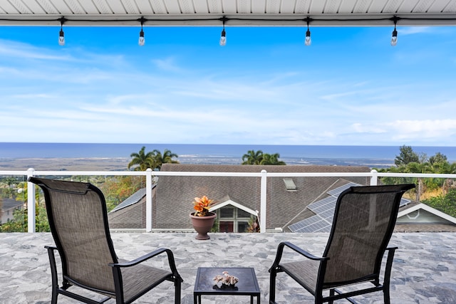 view of patio / terrace with a fire pit and a water view