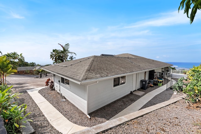 view of property exterior with a water view