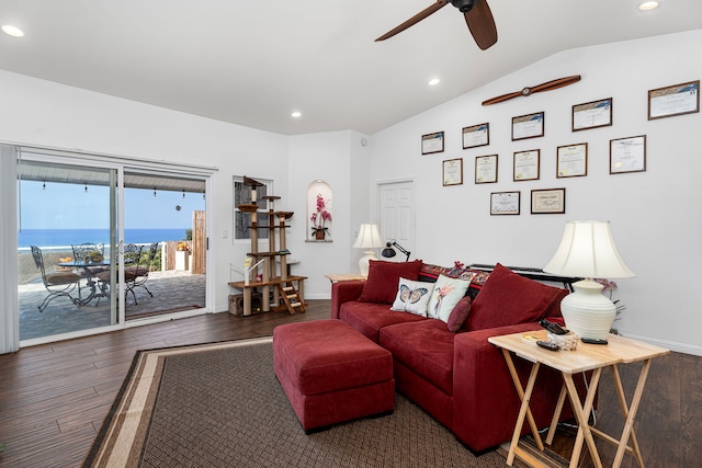 living room with dark hardwood / wood-style floors, ceiling fan, a water view, and lofted ceiling