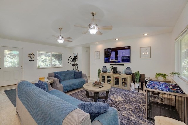 living room with ceiling fan and vaulted ceiling