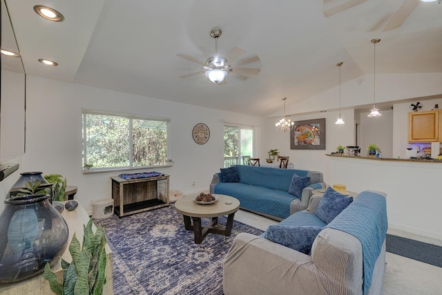 living room featuring vaulted ceiling and ceiling fan with notable chandelier